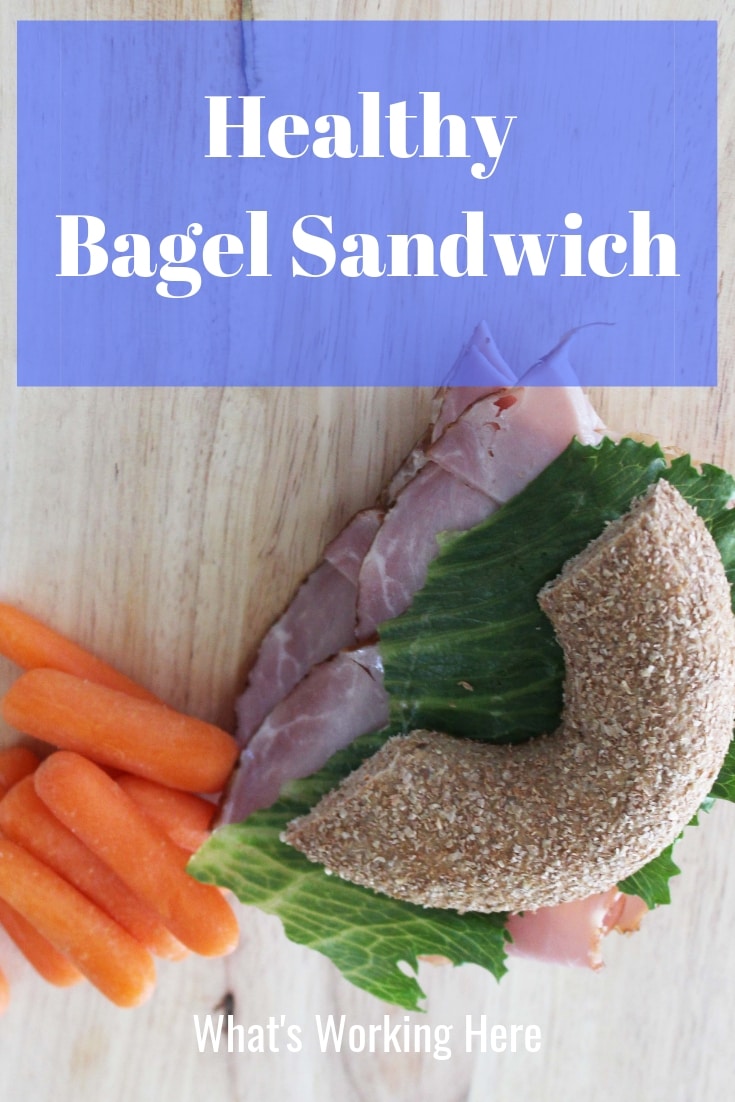 Healthy Bagel Sandwich - ham and cheese sandwich with lettuce on a whole wheat bagel with a side of baby carrots