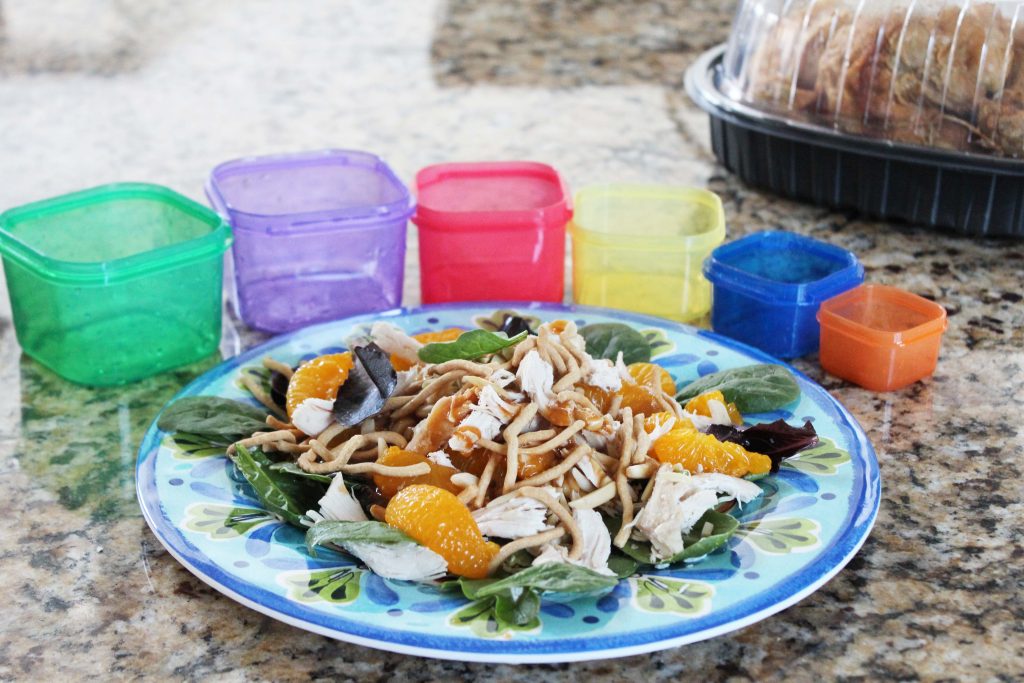 chinese chicken salad with containers and rotisserie chicken